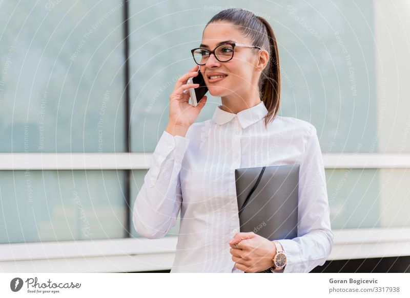 Successful young businesswoman using smartphone outdoors. Financial Industry Business Career To talk PDA Technology Human being Young woman Youth (Young adults)