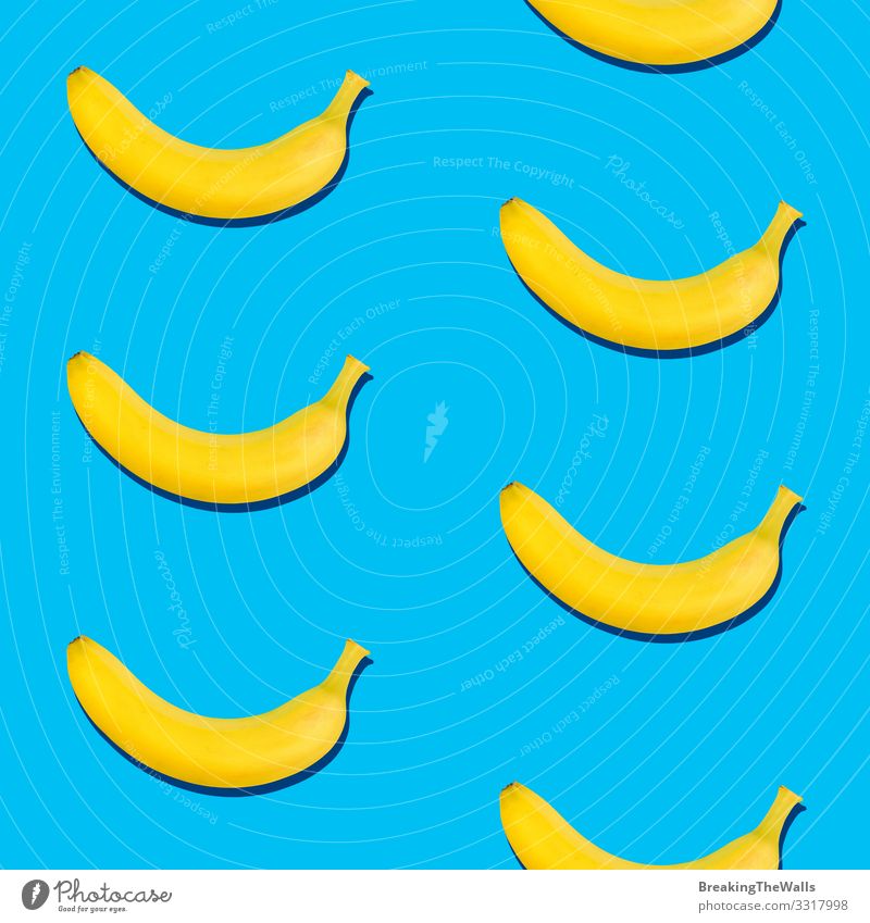 Seamless pattern of bananas on blue background Fruit Vegetarian diet Diet Design Healthy Eating Fresh Blue Yellow Esthetic Exotic Colour Banana Tropical Vitamin