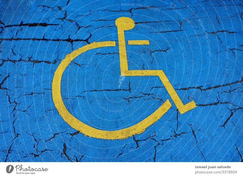 wheelchair road sign on the road on the street in Bilbao city Spain symbol traffic sign traffic signal blue yellow bilbao spain disabled disabled sign
