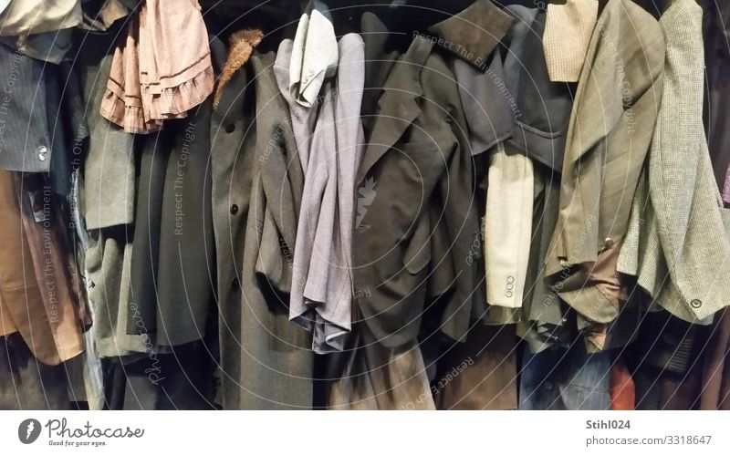 many old jackets hung up next to each other Clothing Dress Suit Jacket Coat outerwear Hang Old Elegant Hideous Blue Brown Gray Black Orderliness Modest Thrifty
