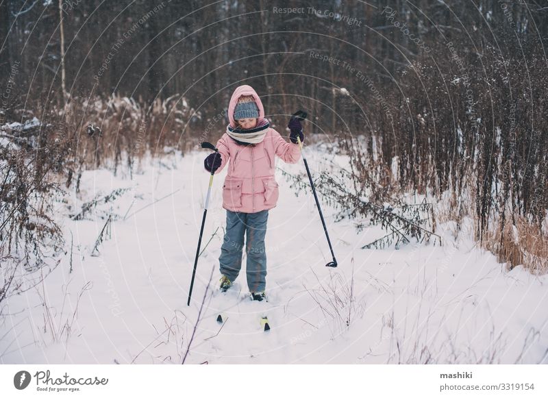 happy child girl skiing in winter snowy forest Joy Happy Relaxation Leisure and hobbies Vacation & Travel Adventure Winter Snow Sports Child