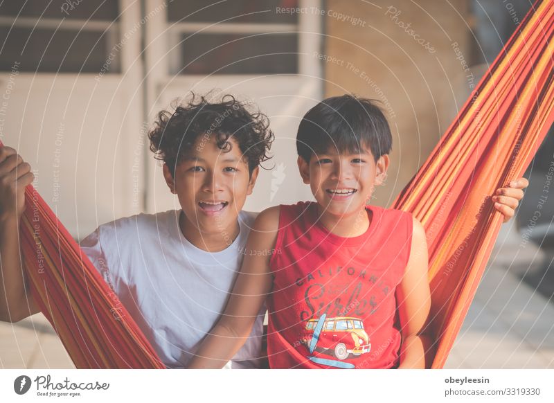 boys stay in the hammock and have fun time Lifestyle Joy Happy Relaxation Vacation & Travel Adventure Summer Garden Entertainment Child Technology Human being