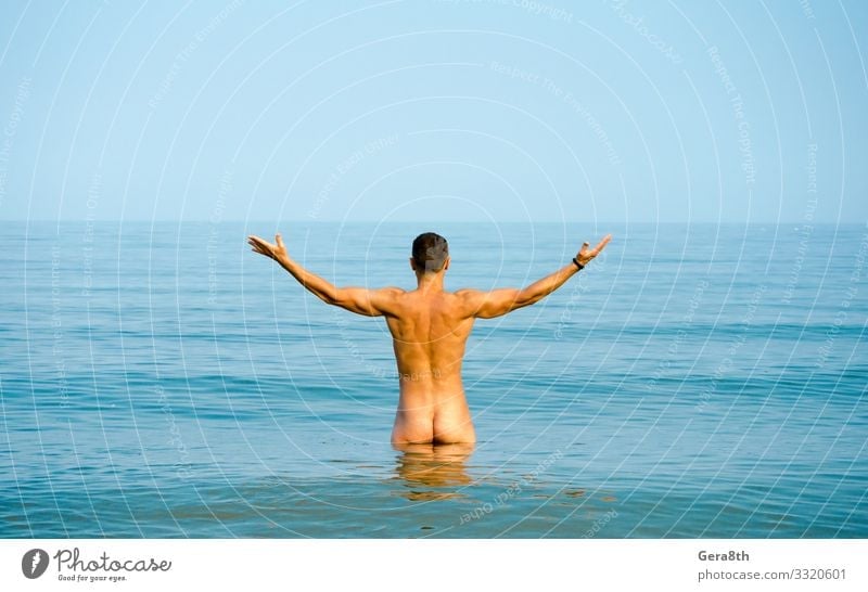 nude man in blue water Beach Ocean Sports Man Adults Bottom Sky Horizon Coast Athletic Naked Blue back bathe Body building breech butt calm Musculature nates