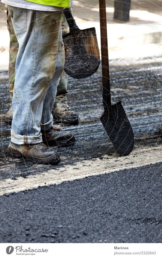 Workers using asphalt paver tools during road construction. Work and employment Industry Machinery Transport Street Highway Vehicle New Maintenance Asphalt