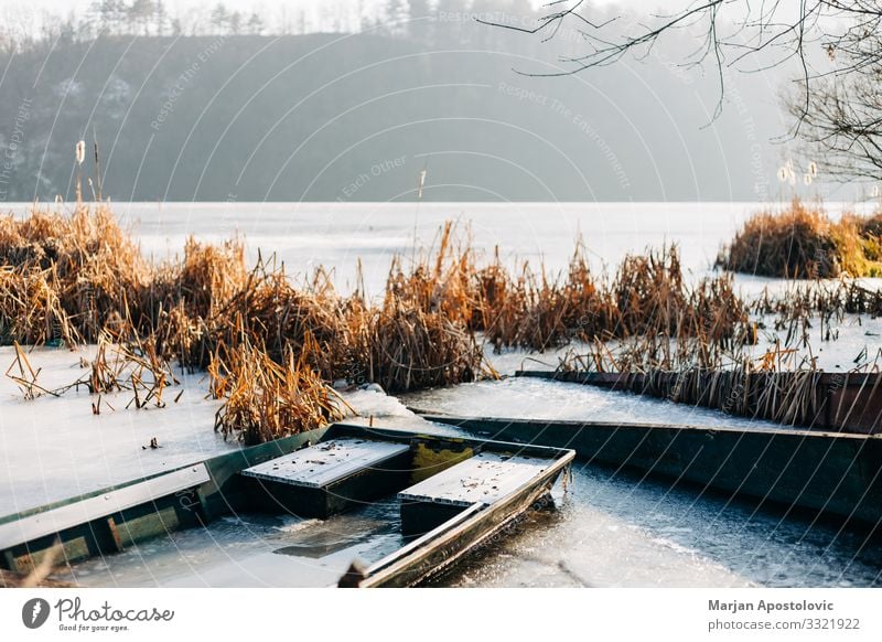 Boats in a frozen lake in winter time Nature Landscape Water Sunlight Winter Weather Ice Frost Lakeside River bank Pond Fishing boat Freeze Cold Moody Peaceful