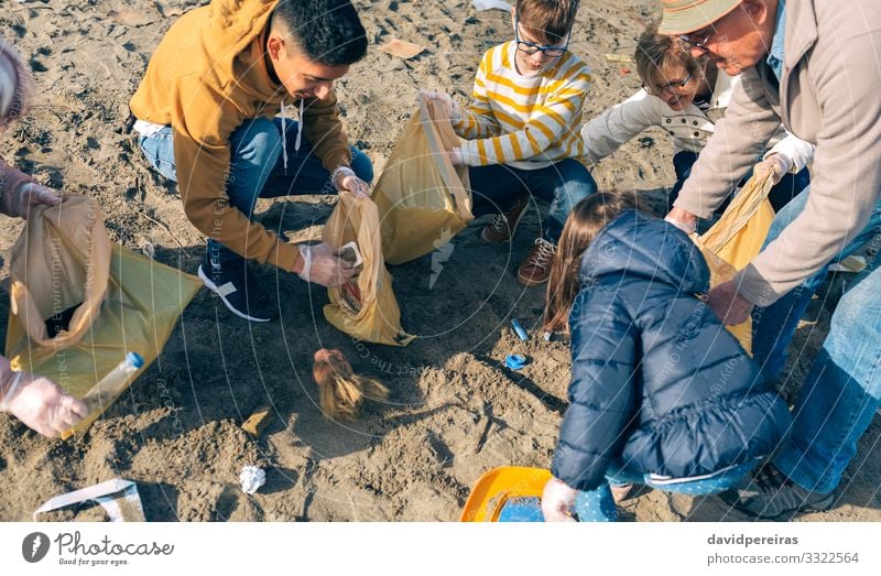 Volunteers cleaning the beach Beach Child Human being Boy (child) Woman Adults Man Family & Relations Group Environment Nature Aircraft Old Smiling Dirty