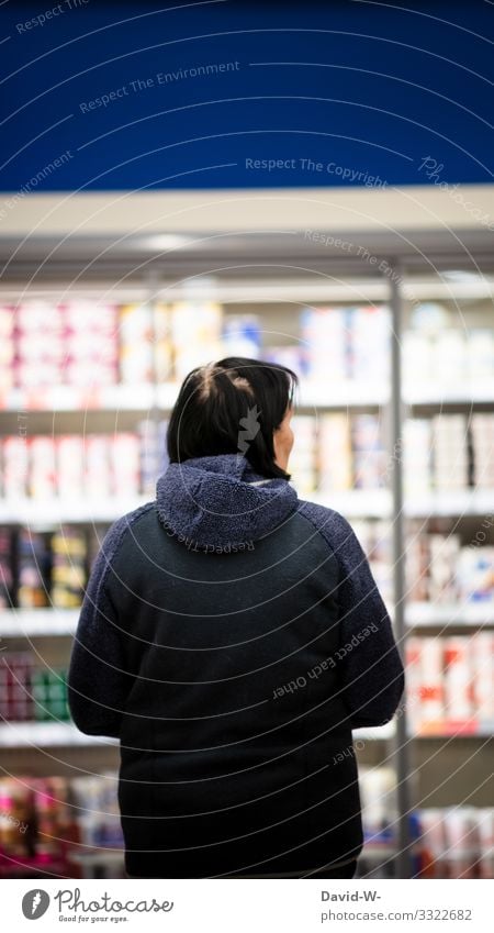 a woman is standing in front of a refrigerator in a grocery store Shopping Trolley Food Supermarket Colour photo Consumption Store premises Human being consumer