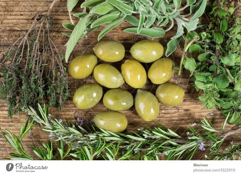 Green olives with several herbs around on wooden table. Eating Vegetarian diet Diet Nature Plant Tree Leaf Fresh Natural oil background branch food healthy
