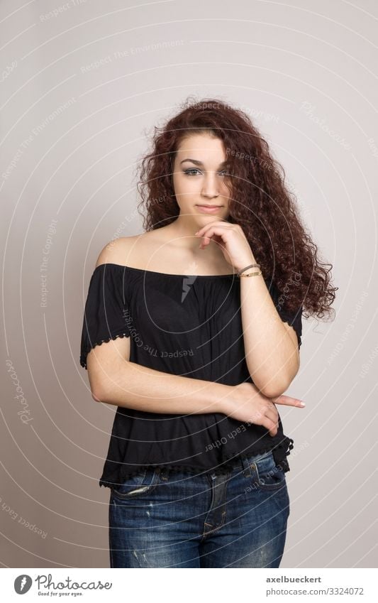 thoughtful young woman with long curly hair Human being Feminine Young woman Youth (Young adults) Woman Adults 1 13 - 18 years 18 - 30 years Jeans Blouse