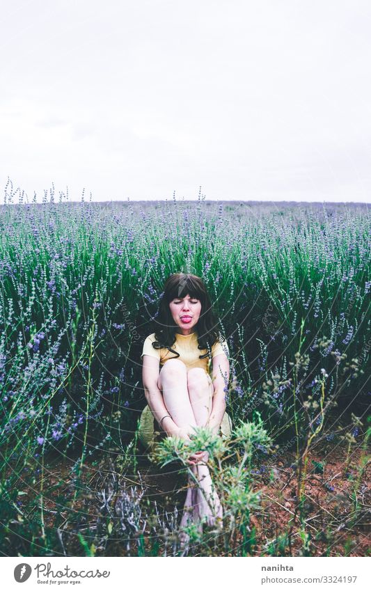 Young brunette woman sitting surrounded by lavender young pretty retro vintage nature natural real candid relax tranquility scene flowers spring springtime
