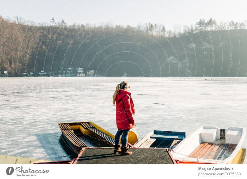 Young woman standing by the frozen lake Lifestyle Vacation & Travel Adventure Winter Human being Feminine Youth (Young adults) Woman Adults 1 30 - 45 years