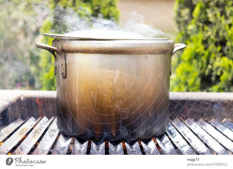 Preparation of soup in a pot, in nature. Meat Soup Stew Pot Vacation & Travel Camping Kitchen Nature Warmth Forest Mobile home Metal Large Hot Tradition