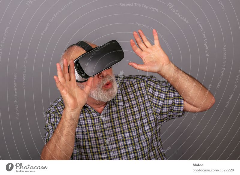 Man wearing virtual reality glasses. Studio recording, grey background Really Virtual VR Eyeglasses Panorama (Format) Playing Technology gadget Digital
