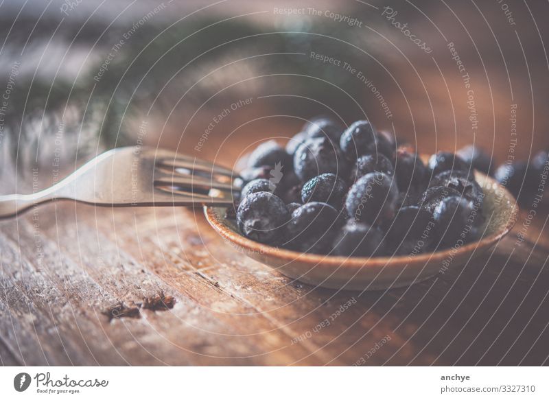 Blueberries with fork Food Fruit Nutrition Breakfast Organic produce Bowl Fork Lifestyle Style Table Stone Wood Eating To enjoy Good Delicious Juicy Brown