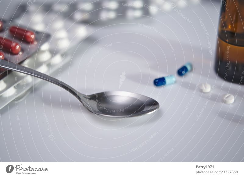 Cough syrup on spoon Pharmaceutics Spoon Pill Fluid Healthy Health care Colour photo Close-up Detail Copy Space bottom
