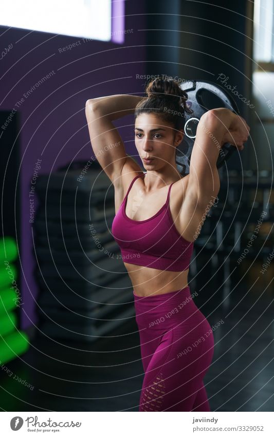 Athletic woman doing triceps push-ups with a barbell plate Plate Lifestyle Personal hygiene Body Wellness Club Disco Sports Human being Feminine Young woman