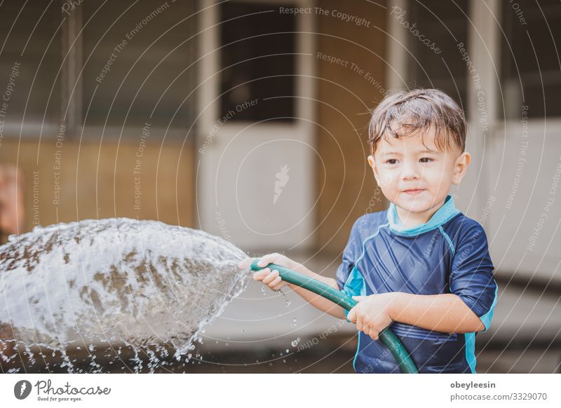cute young boy playing outside with water in nature Joy Happy Relaxation Leisure and hobbies Playing Summer Child School Study Human being Boy (child) Infancy