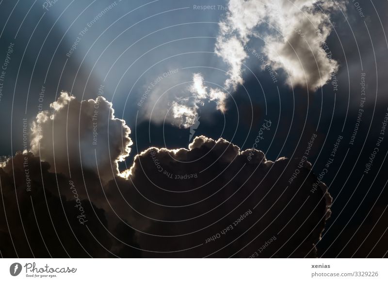 Cloud drama with sunrays Environment Nature Sky Sky only Clouds Sunlight Climate Climate change Weather Storm Illuminate Threat Dark Blue White Sunbeam Dramatic