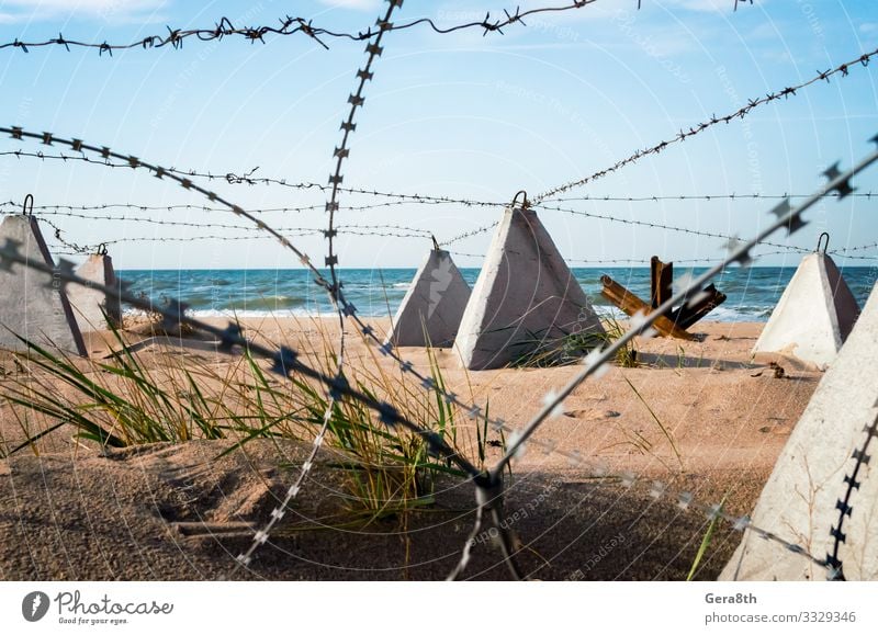 barbed wire on the beach near the sea in Crimea Vacation & Travel Beach Ocean Nature Landscape Sand Sky Clouds Coast Concrete Blue White Safety (feeling of) War