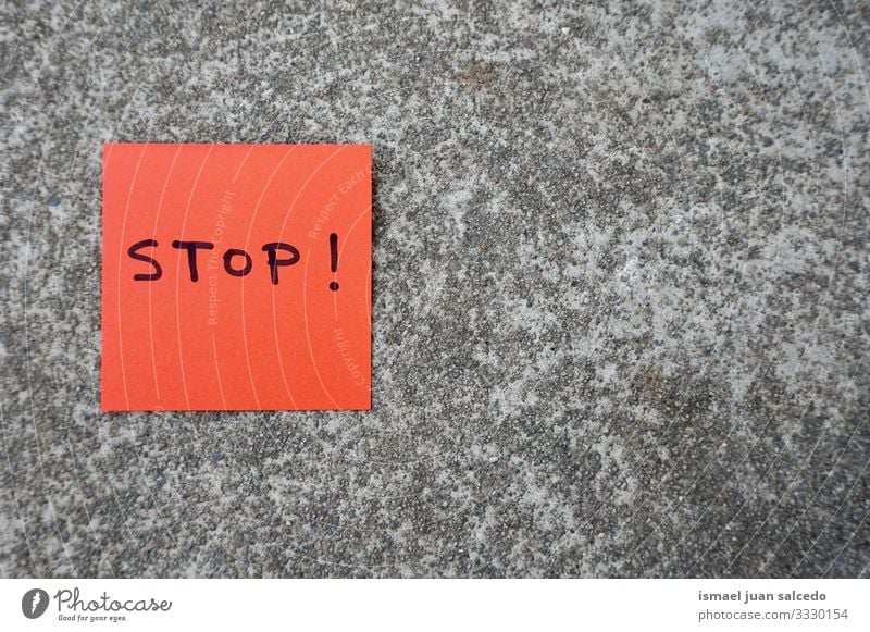 stop handwritten on the red paper on the wall note message sticky isolated sign notice post memo text communication postit word writing letters concept advice