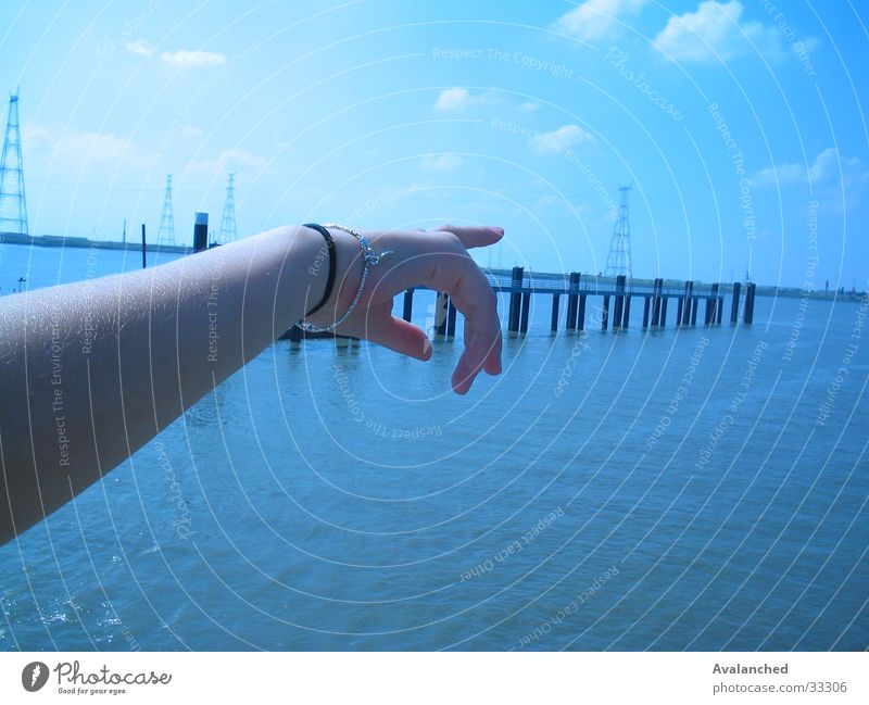Showing the arm Ocean Schelde Fingers Clouds Woman Poverty Wharf Water bracelet Blue