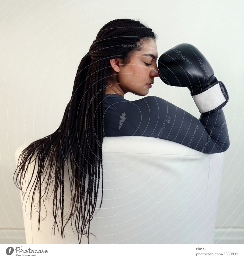 Nikolija ::: Young woman with braids and boxing glove in an armchair Armchair Boxing glove Feminine Woman Adults 1 Human being T-shirt Brunette Long-haired