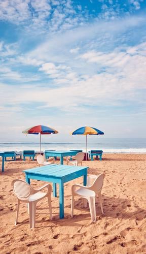 Tables and chairs on a tropical beach. Exotic Relaxation Vacation & Travel Tourism Trip Summer Summer vacation Beach Ocean Island Chair Restaurant Sand Sky