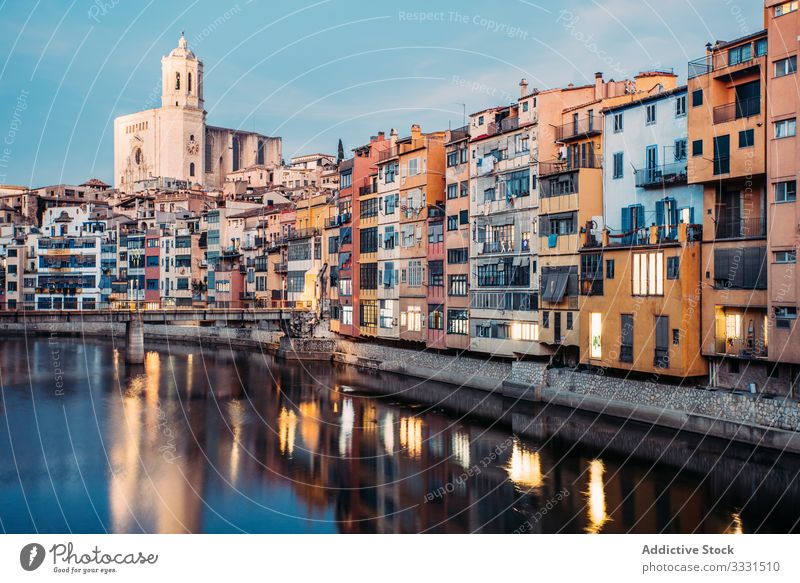Scenic landscape of houses on promenade in daytime Girona apartment building locate canal water bridge scenery town summer architecture travel city waterfront