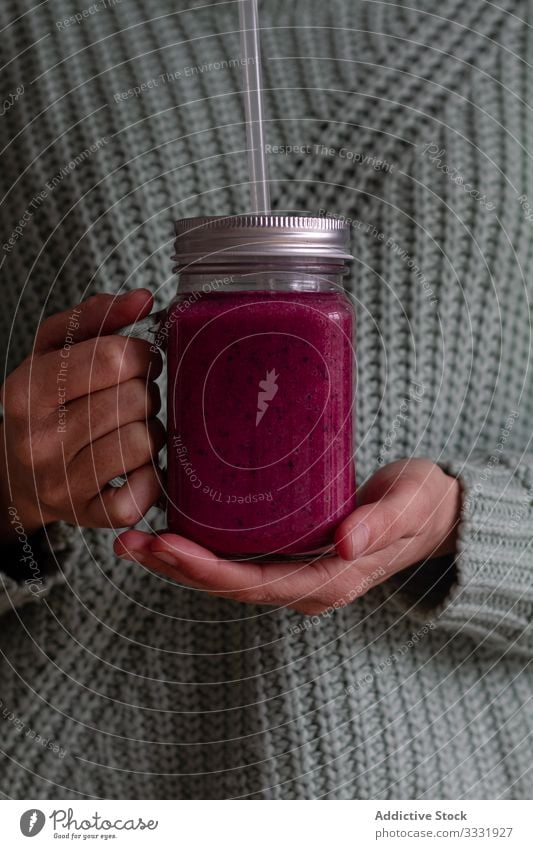 Person holding glass jug of delicious berry smoothie jar mix fresh healthy beverage vitamin detox fruit drink dessert shake straw food hand nutrient person