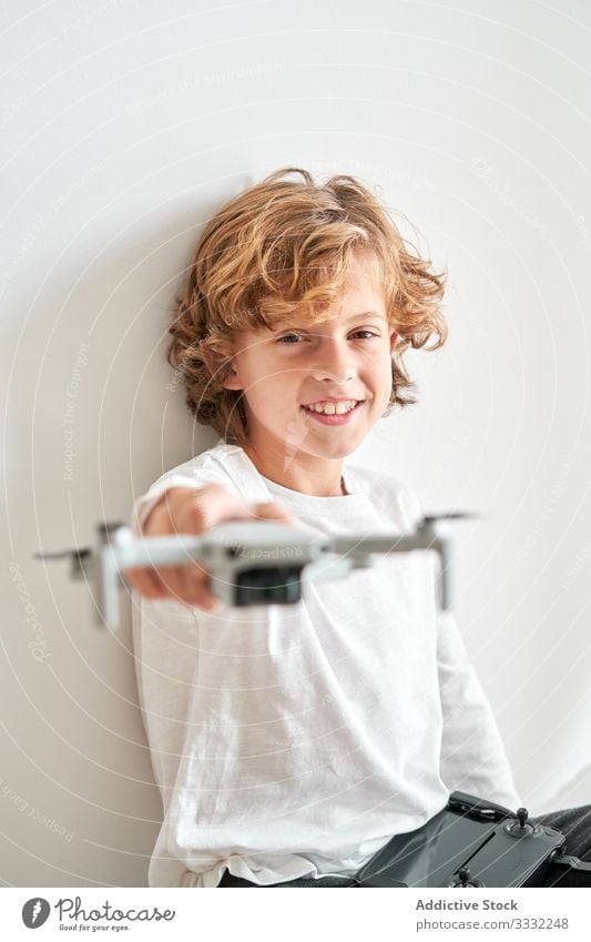 Child manipulating a drone and the remote control just given to him camera filming hobby robot motion aerial technology photography pilot discovery video sky