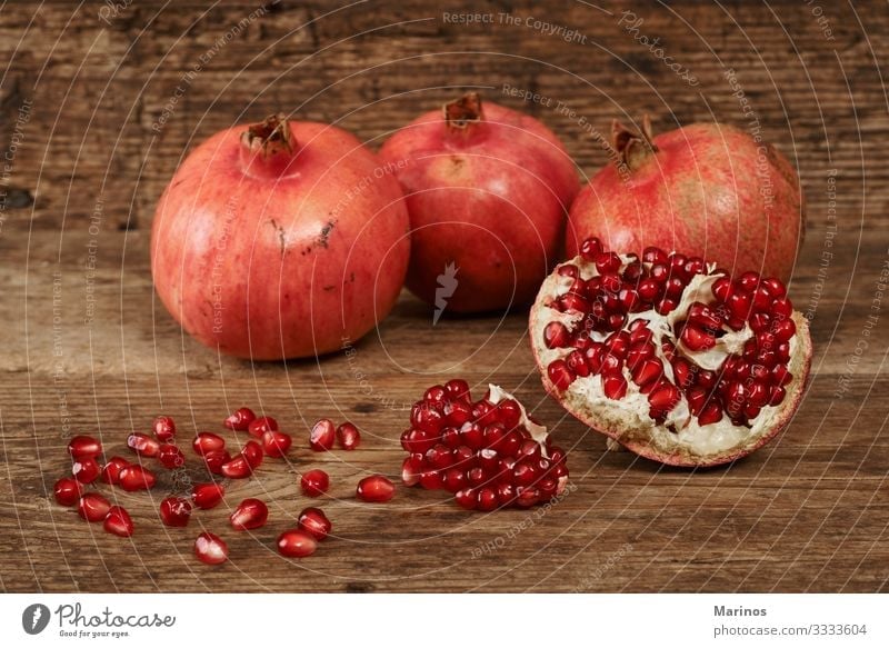ripe pomegranate fruits on wooden table. Fruit Dessert Vegetarian diet Diet Juice Garden Table Wood Fresh Natural Juicy Red Colour dieting health Vitamin