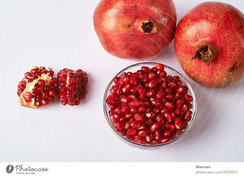 pomegranate fruits and seeds on white background. Fruit Dessert Vegetarian diet Diet Juice Garden Fresh Natural Juicy Red Colour dieting health Vitamin Organic