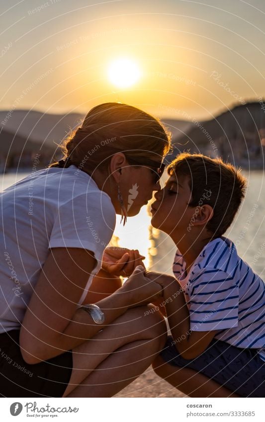 Mother and son looking each other at sunset Lifestyle Joy Happy Leisure and hobbies Playing Vacation & Travel Summer Sun Beach Ocean Mother's Day Child