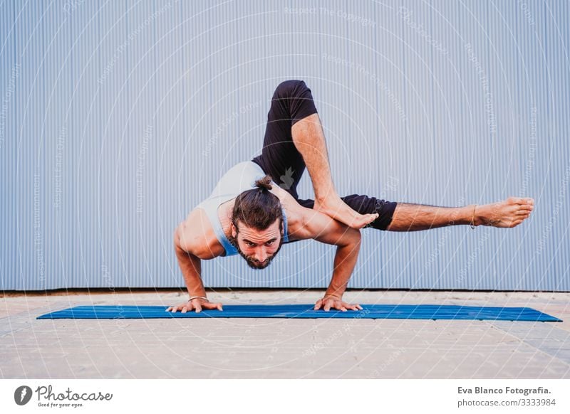 man in the city practicing yoga sport. blue background. healthy lifestyle Blue background Yoga Man City Town Lifestyle Muscular Concentrate Position Human being