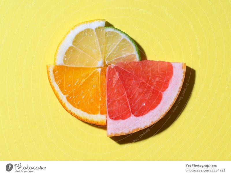 Citrus fruits slices in sunlight. Summer fruits context Food Fruit Beautiful weather Fresh Bright above view circle colorful Conceptual design detox food
