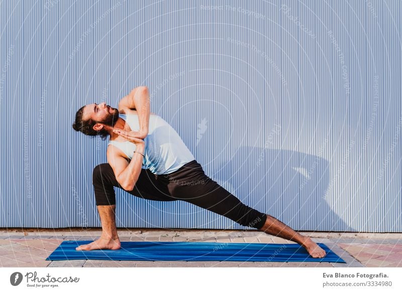 man in the city practicing yoga sport. blue background. healthy lifestyle Yoga Man Sports Healthy Exterior shot City Blue background Muscular