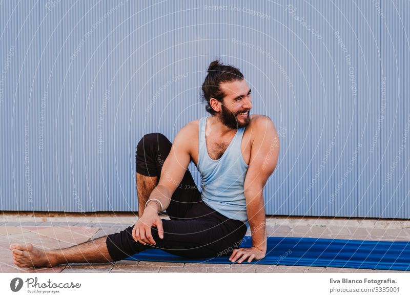 man in the city practicing yoga sport and smiling. blue background. healthy lifestyle Yoga Man Sports Healthy Exterior shot City Blue background Muscular