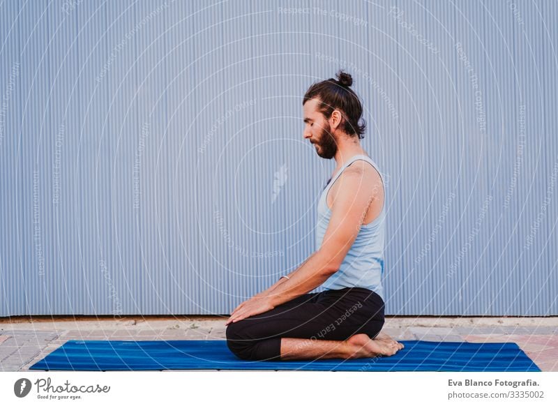 man in the city practicing yoga sport. blue background. healthy lifestyle Yoga Man Sports Healthy Exterior shot City Blue background Muscular