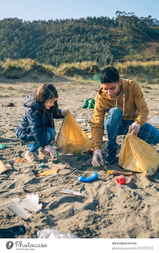 Volunteers picking up trash on beach Joy Happy Camping Beach Child Teacher Work and employment Human being Woman Adults Man Environment Sand Plastic To enjoy