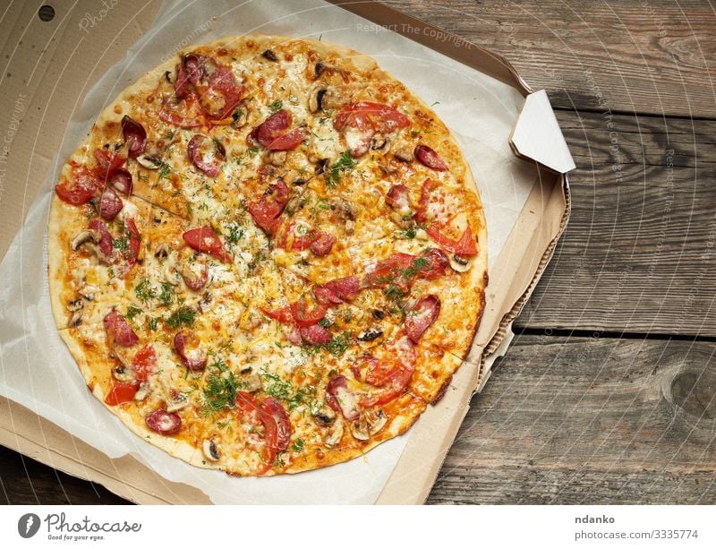 baked round pizza with smoked sausages Meat Sausage Cheese Vegetable Dough Baked goods Lunch Dinner Fast food Table Restaurant Packaging Package Wood Fresh Hot