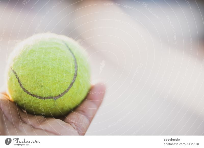 yellow tennis ball being held out in the light Lifestyle Style Design Freedom Sports Ball Art Stand Colour photo