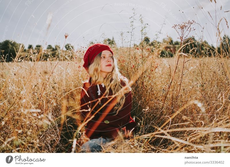 Young woman in a field in a sunny day calm tranquility silence nature portrait portraiture red blonde summer autumn backlight vintage warm comfort