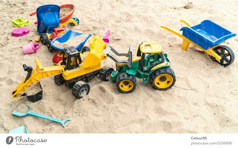 Colourful toys in the sand Joy Summer Beach Kindergarten Child Nature Sand Yellow Background picture Excavator toys for children Sandpit Infancy out variegated