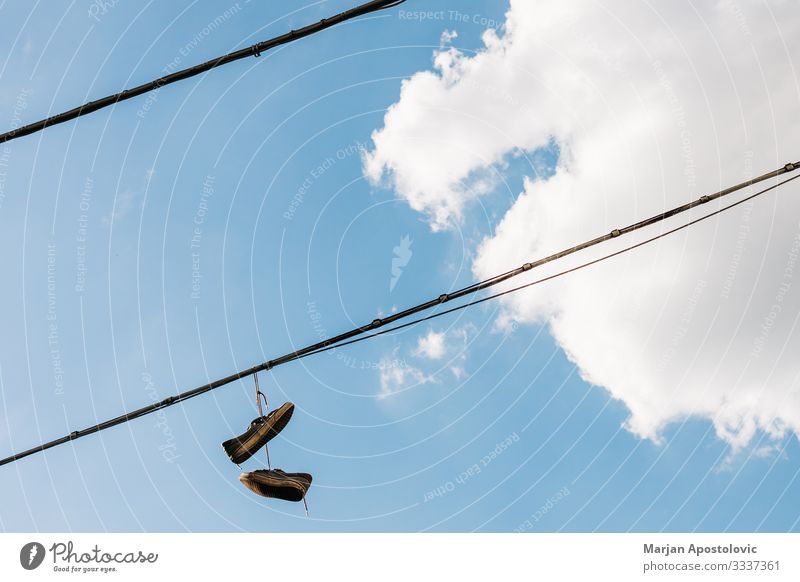 Old shoes hanging by the laces in the sky Sky Clouds Small Town Tall Curiosity Fear of the future Disbelief Freedom Frustration Idea Inspiration