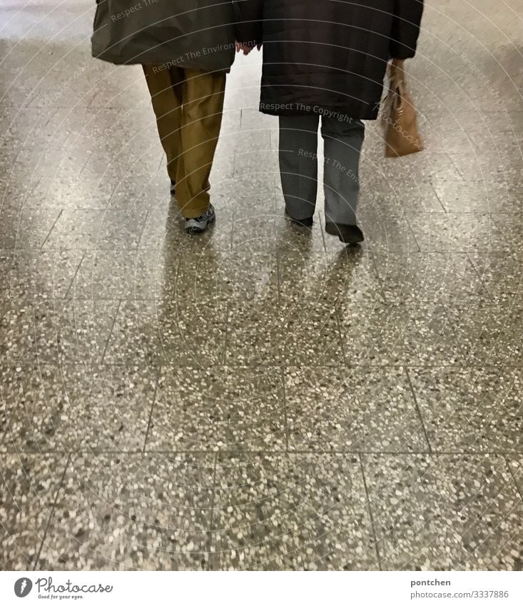 Love-Two seniors walk hand in hand over ground Human being Masculine Feminine Female senior Woman Male senior Man Partner Senior citizen 2 60 years and older