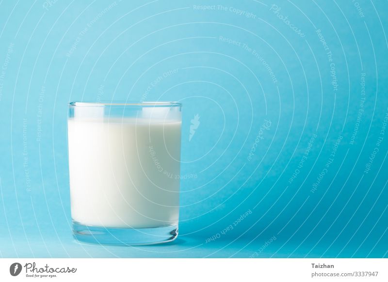 Glass milk on a blue background Beverage Milk Cup Healthy Healthy Eating Life Health care Colour photo Multicoloured Studio shot Deserted Copy Space right