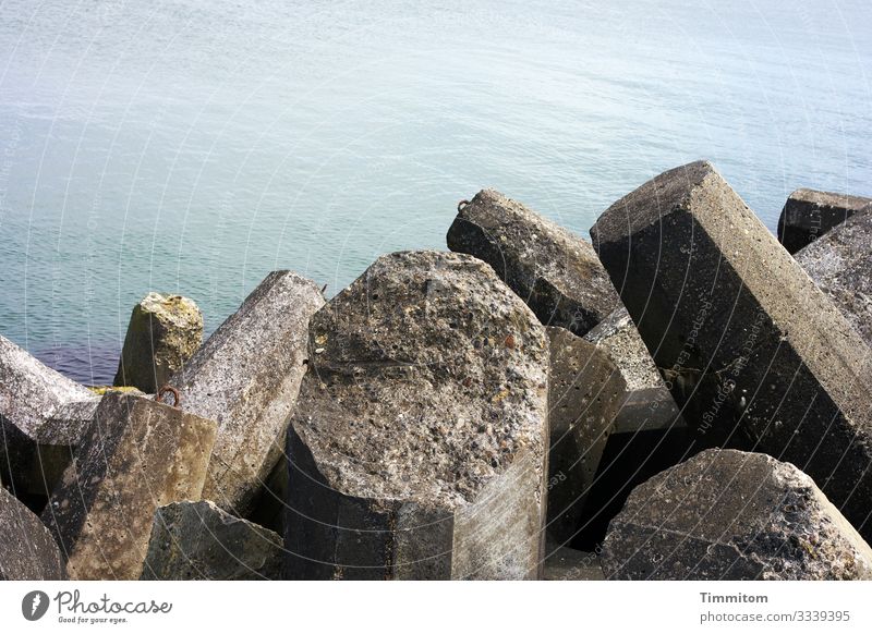 Breakwater and very calm North Sea breakwater Concrete shape Hard coarsely Protection Water Calm Denmark Deserted antagonism Beach Exterior shot Sky Blue