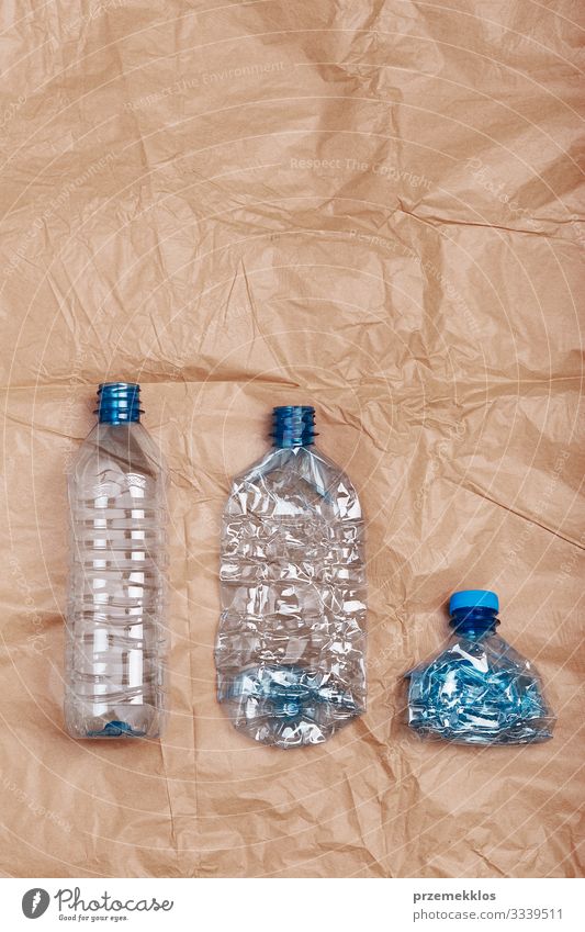 Squashed empty plastic bottles put in a row Bottle Save Environment Container Paper Plastic Blue Brown Environmental pollution Environmental protection