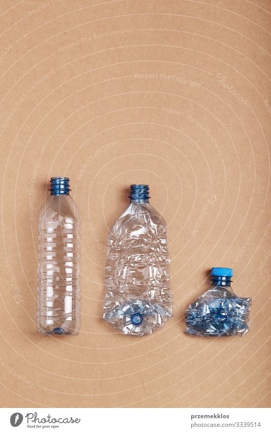 Squashed empty plastic bottles put in a row Bottle Save Environment Container Paper Packaging Package Plastic packaging Blue Disaster Environmental pollution