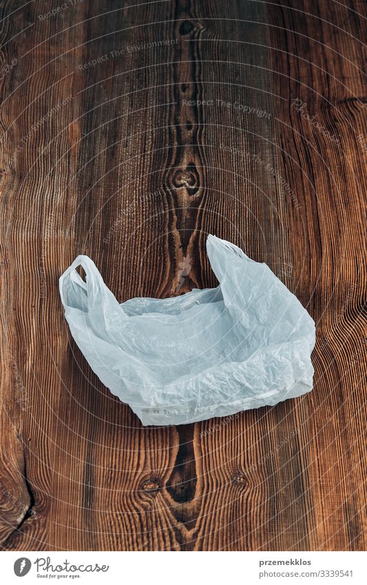 White empty plastic bag floating over wooden background Shopping Environment Container Packaging Package Plastic packaging Wood Environmental pollution